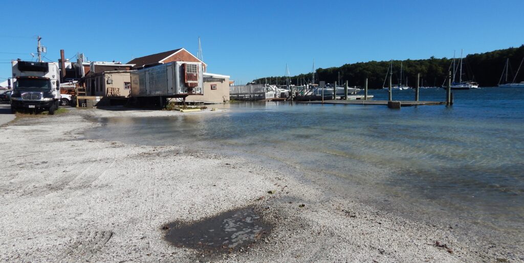 a beach with a building and a truck parked on it (MyCoast AI)