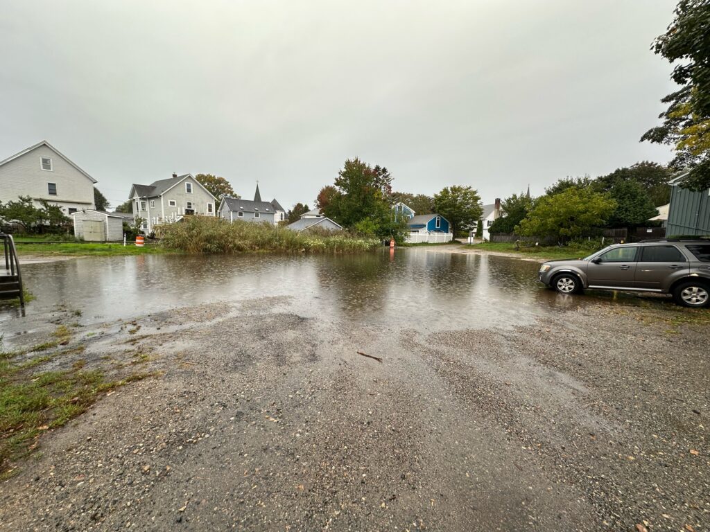 a flooded street with houses and cars (MyCoast AI)