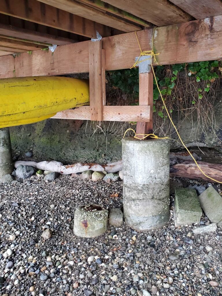 a bucket of water under a wooden shelter (MyCoast AI)