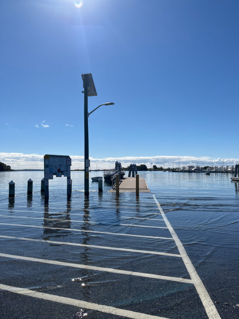 a road with a light post and a body of water in the background (MyCoast AI)
