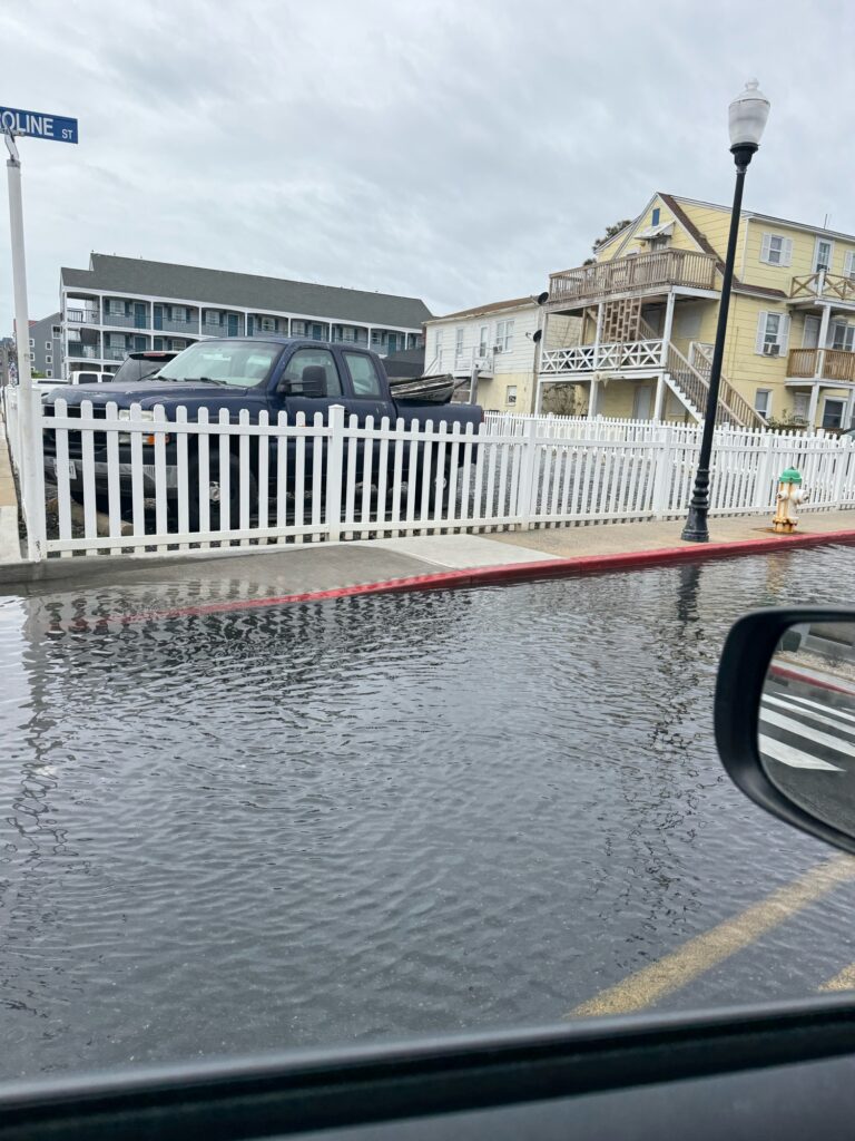 a car driving on a flooded street (MyCoast AI)