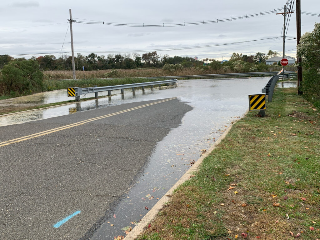 a wet road with water on the side (MyCoast AI)