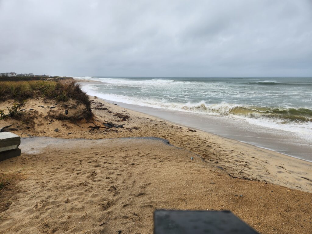a sandy beach with waves crashing on it (MyCoast AI)