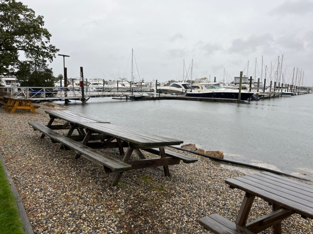a picnic table sits by a body of water (MyCoast AI)