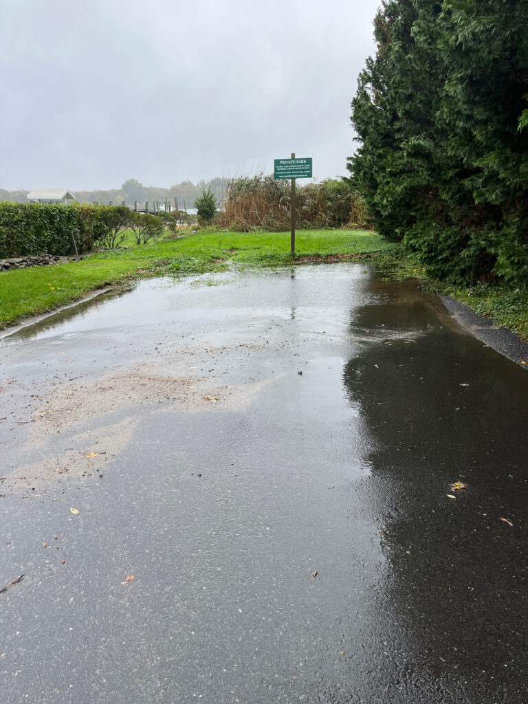 a wet road with a sign (MyCoast AI)