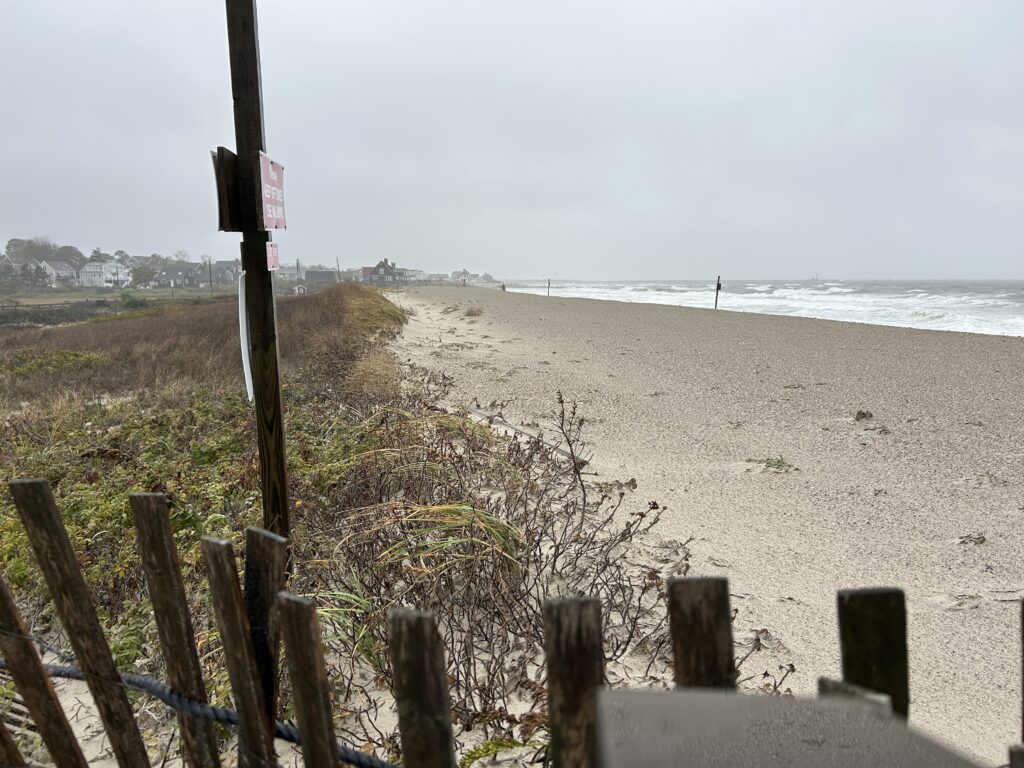 a beach with a fence and a sign (MyCoast AI)