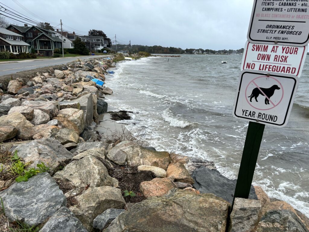 a sign on a rocky beach (MyCoast AI)