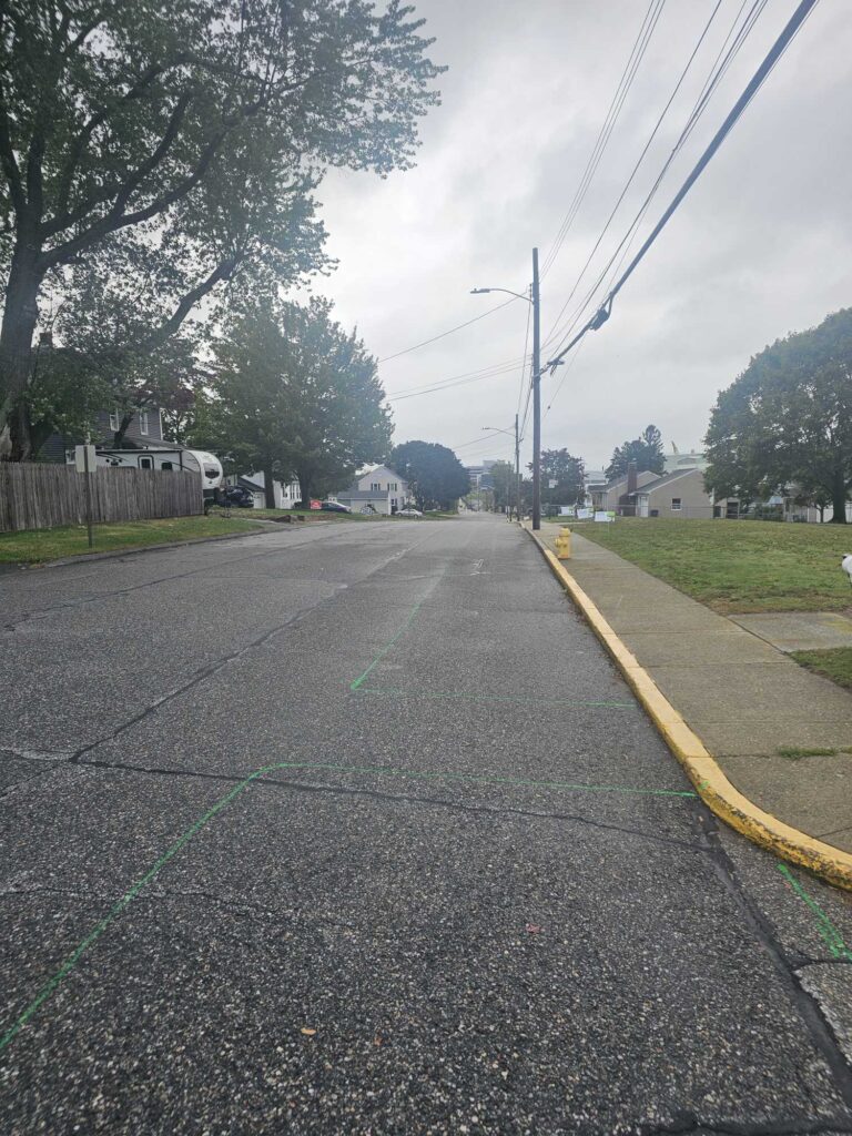 a road with a fence and trees on the side (MyCoast AI)