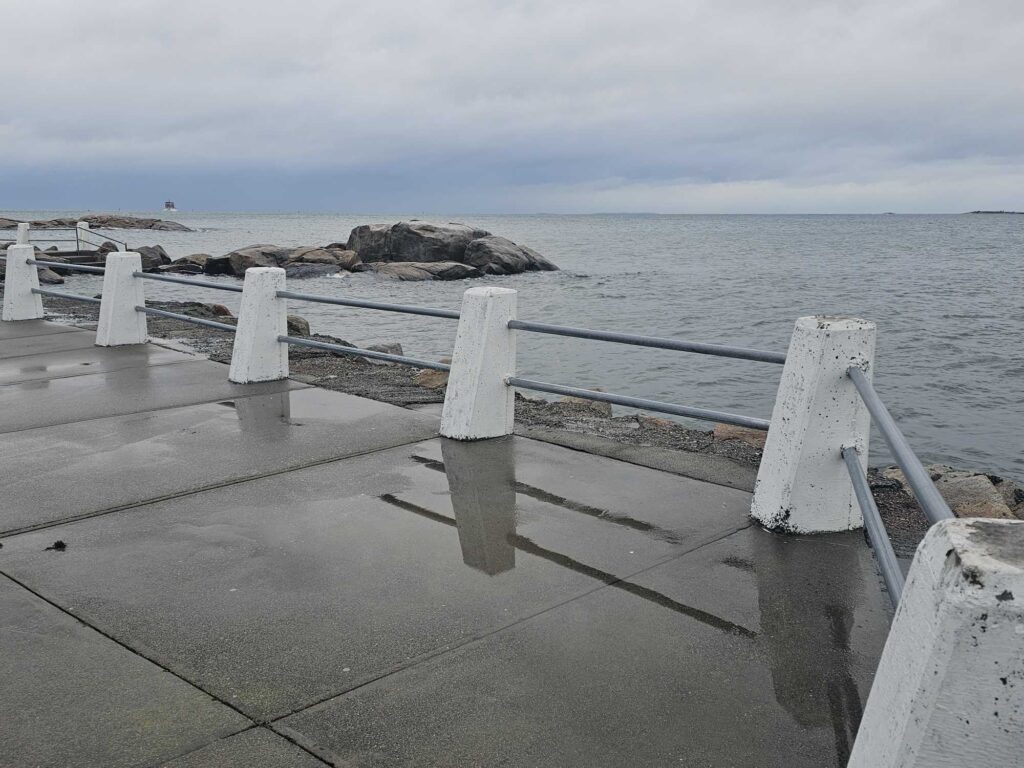 a bench sits on a pier (MyCoast AI)