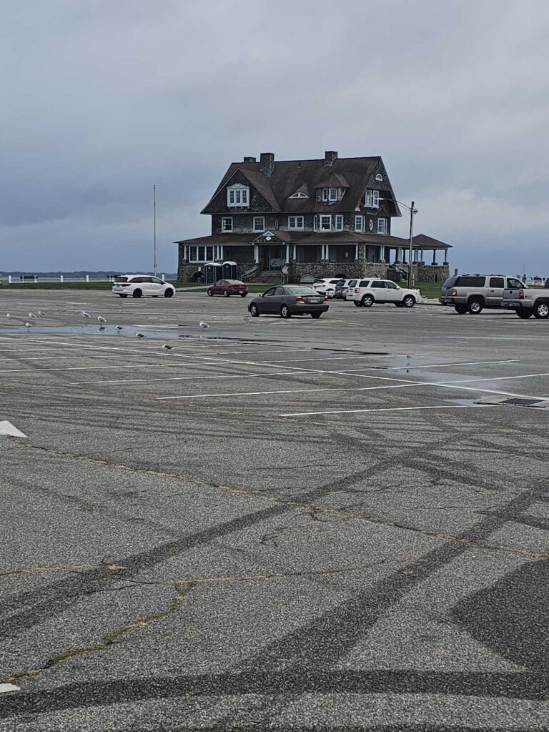 a parking lot with cars and a building in the background (MyCoast AI)