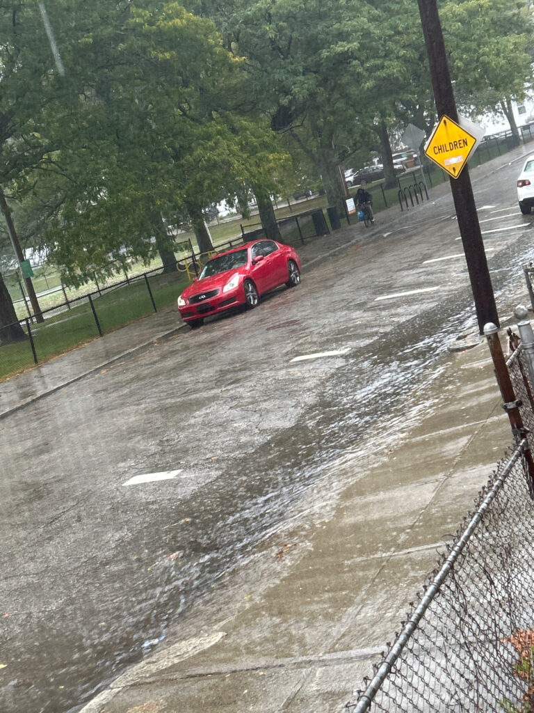 a red car on a wet road (MyCoast AI)