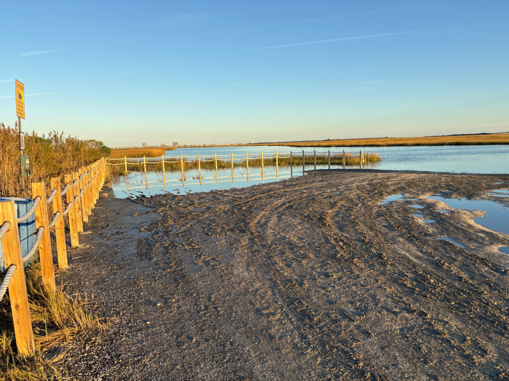 a beach with a fence and a body of water (MyCoast AI)
