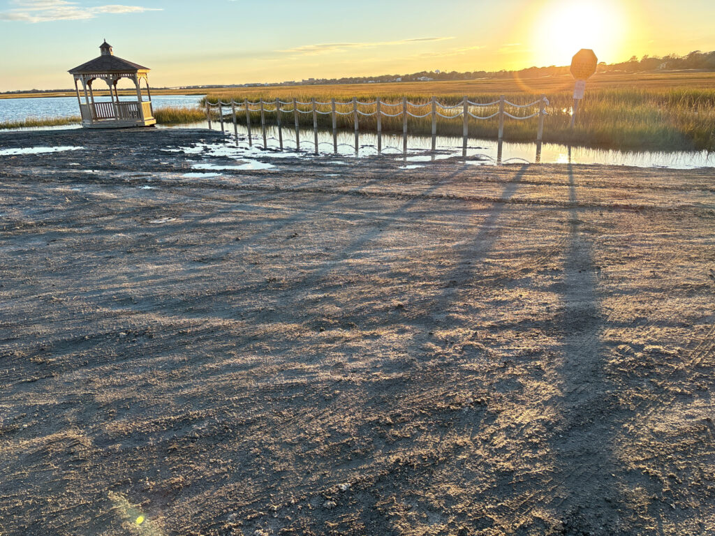 a beach with a pier and a sunset (MyCoast AI)