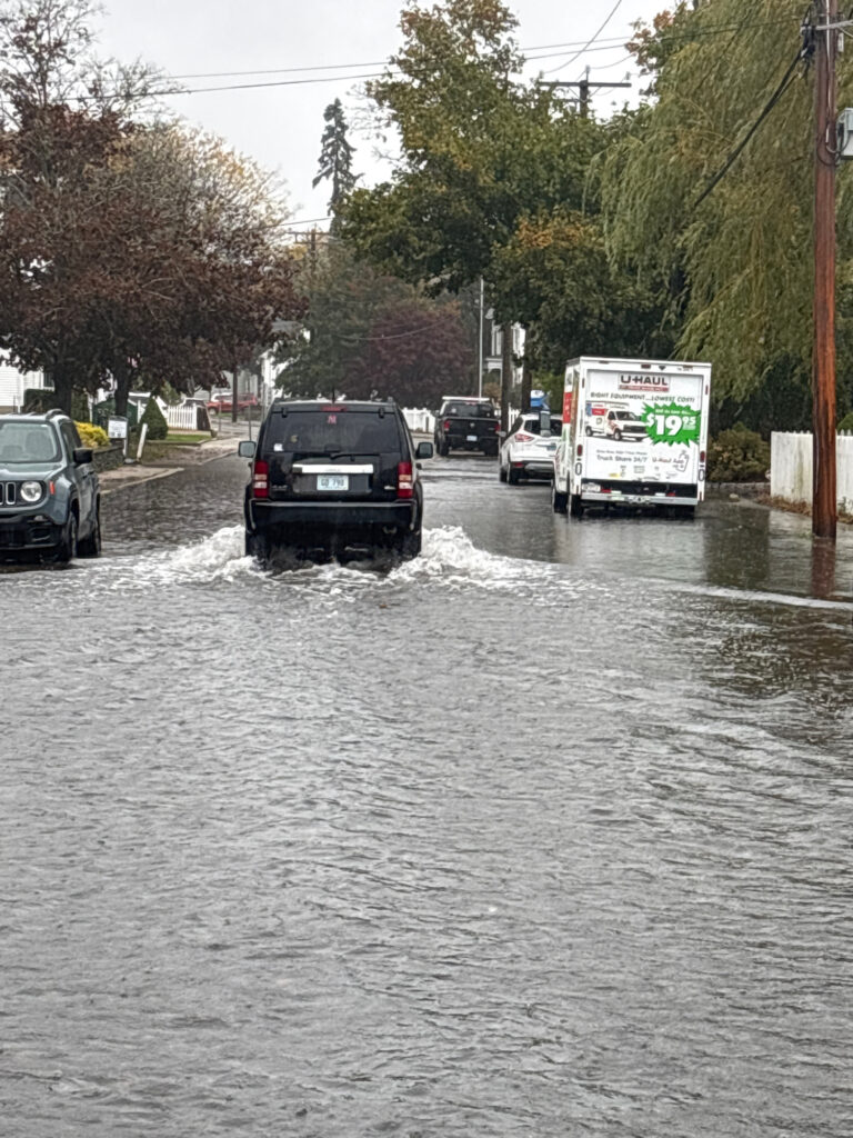 a flooded street with cars and trucks (MyCoast AI)