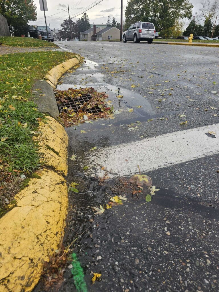 a sidewalk with a curb and a car parked on the side (MyCoast AI)