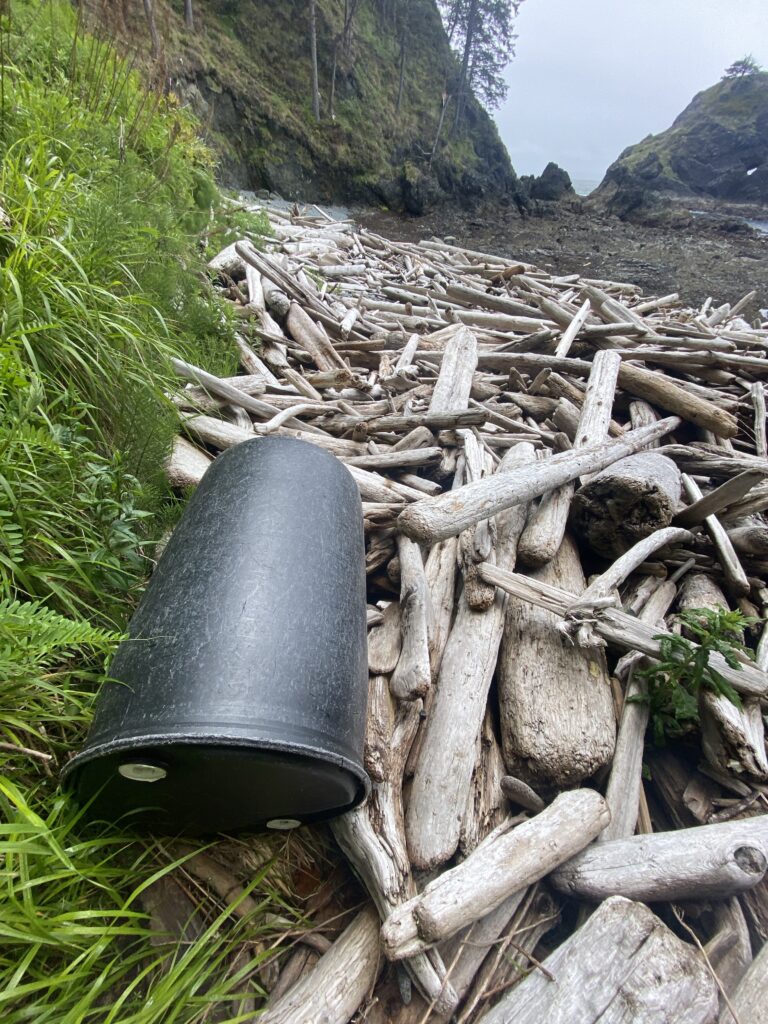 a black barrel on a pile of wood (MyCoast AI)