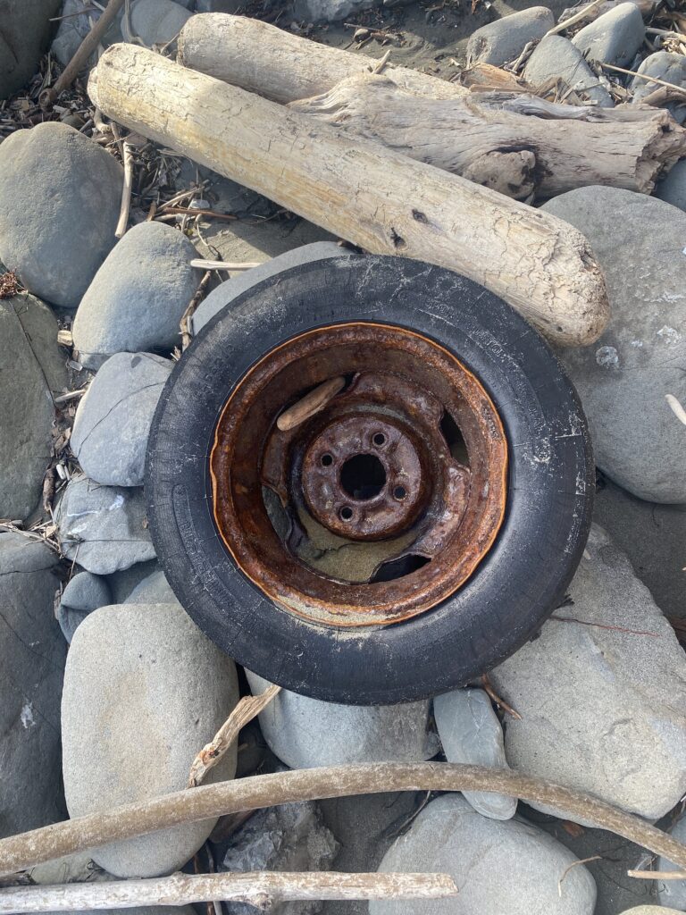 a tire on a pile of rocks (MyCoast AI)