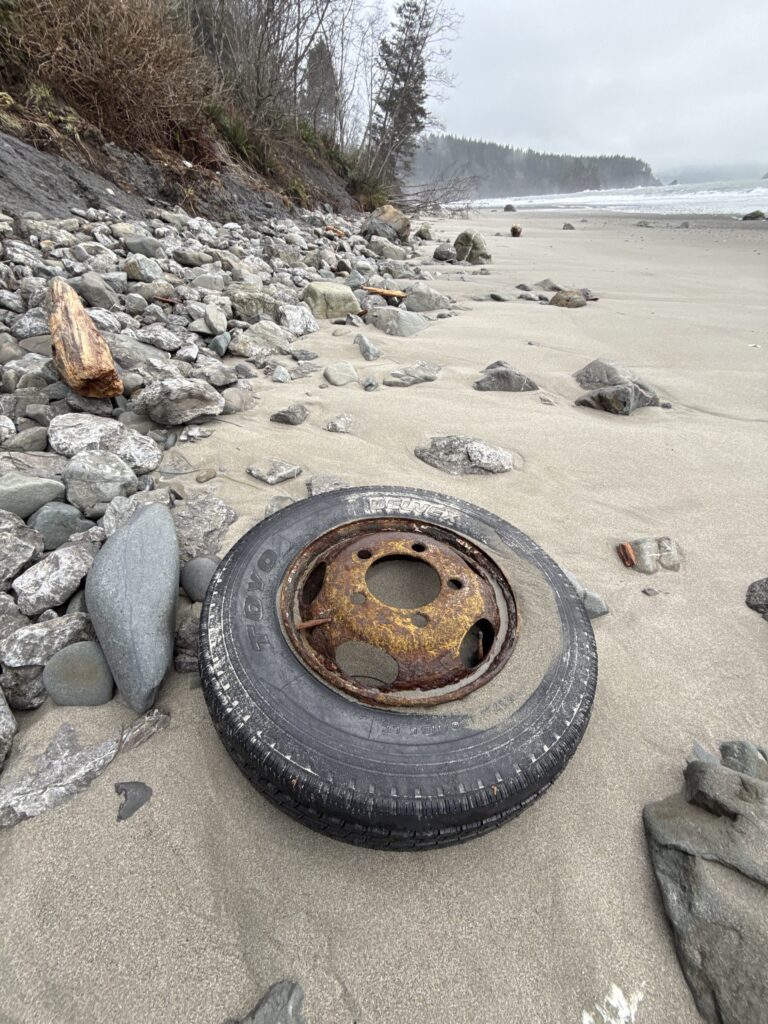 a tire on a rocky beach (MyCoast AI)