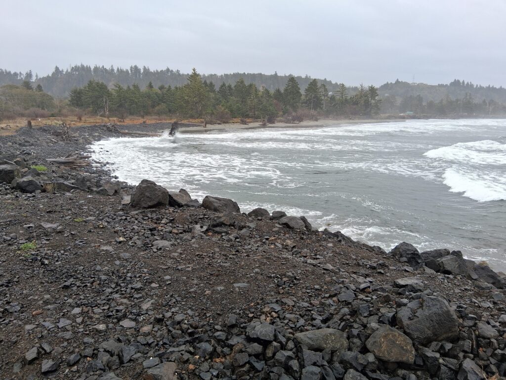 a rocky beach with waves crashing (MyCoast AI)