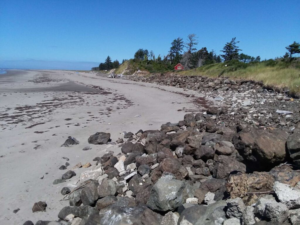 a rocky beach with a red house (MyCoast AI)