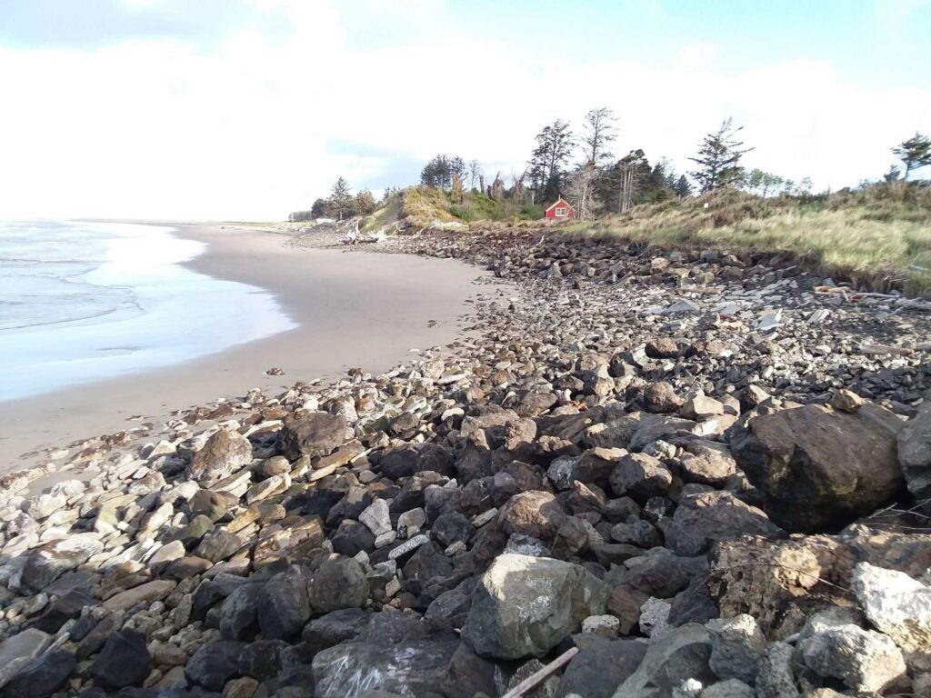 a rocky beach with a red tent (MyCoast AI)