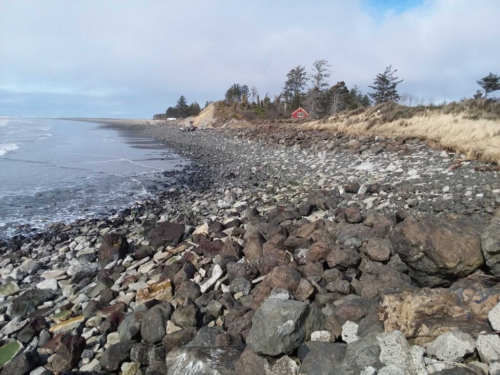 a rocky beach with a red house (MyCoast AI)
