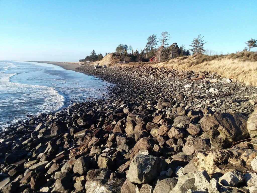 a rocky beach with a body of water in the background (MyCoast AI)
