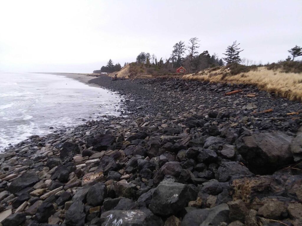 a rocky beach with a red house (MyCoast AI)