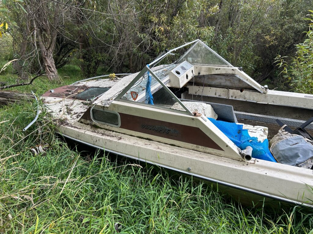 a boat is wrecked in the grass (MyCoast AI)