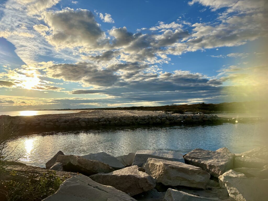 a body of water with rocks and a cloudy sky (MyCoast AI)