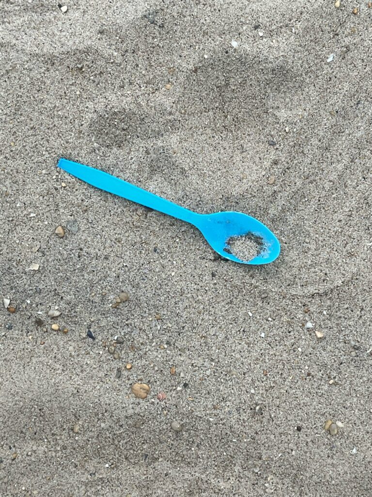 a pair of blue scissors on the ground (MyCoast AI)