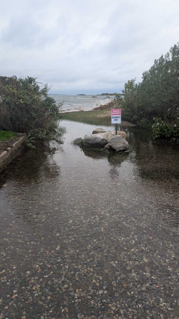 a river with rocks and a sign (MyCoast AI)