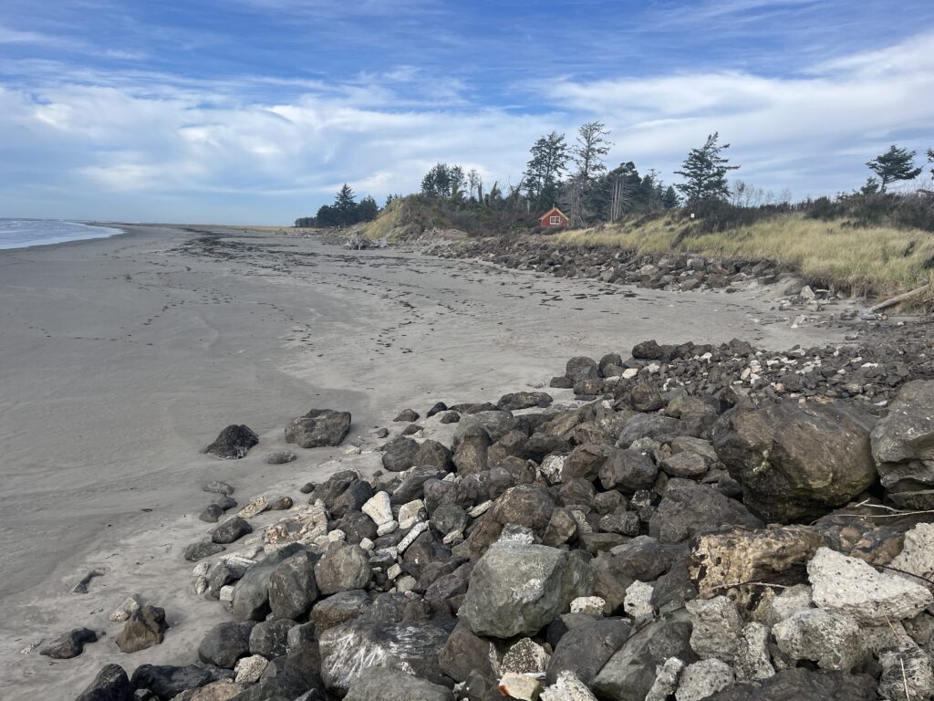 a rocky beach with a red tent (MyCoast AI)