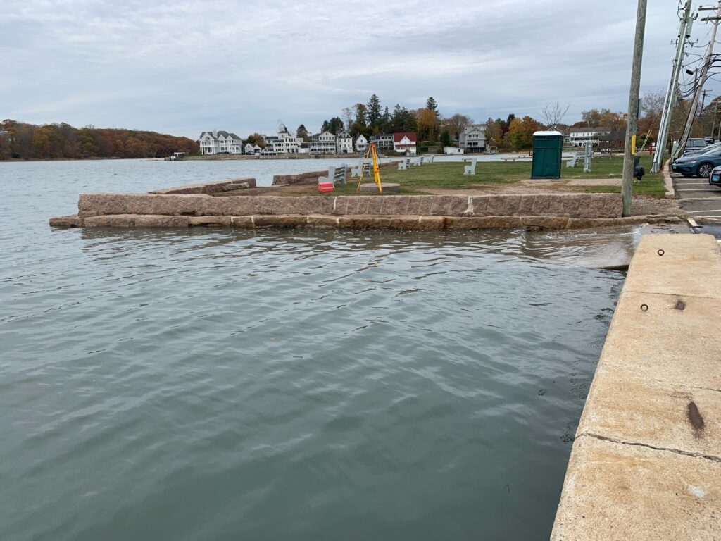 a body of water with a concrete wall and a concrete wall (MyCoast AI)