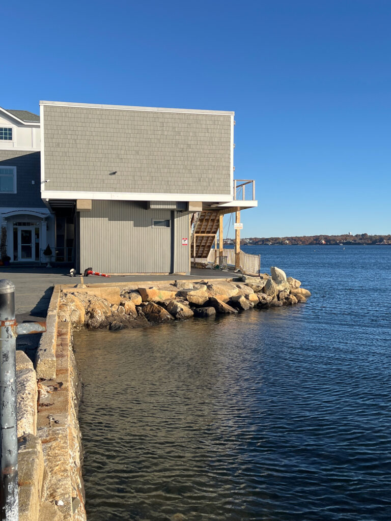 a building next to a body of water (MyCoast AI)