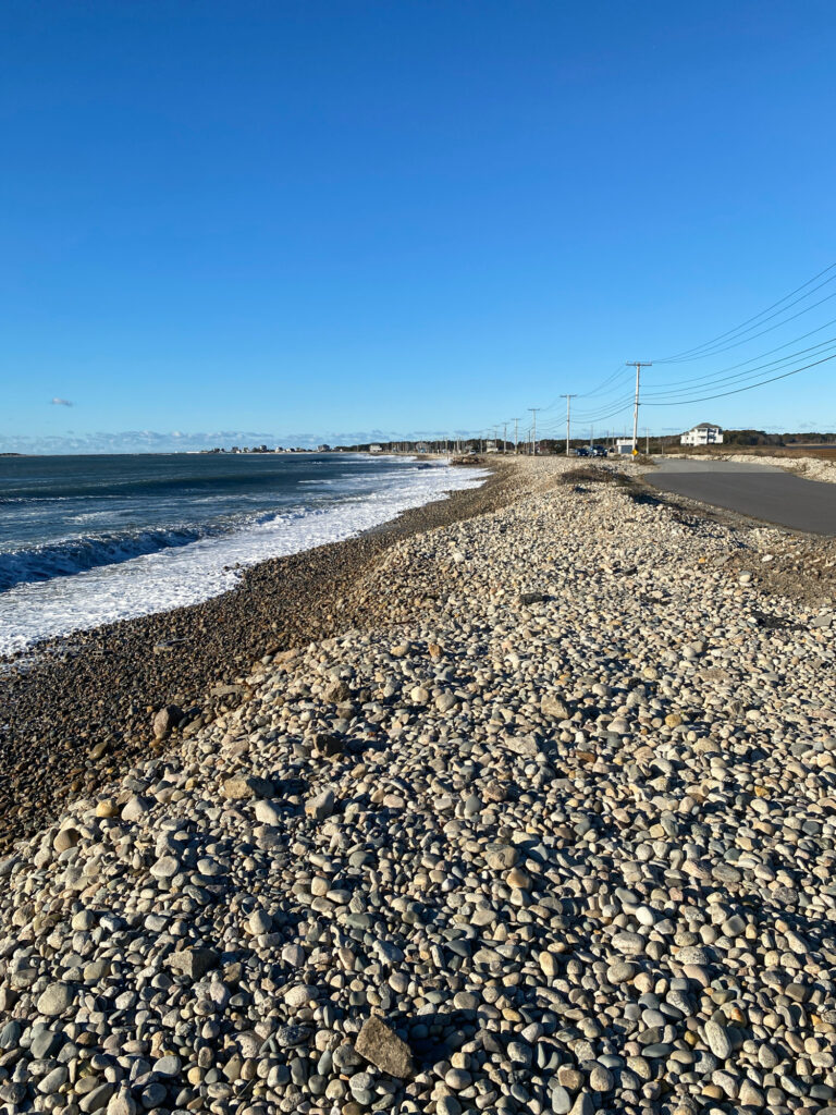 a rocky beach with water and a road (MyCoast AI)