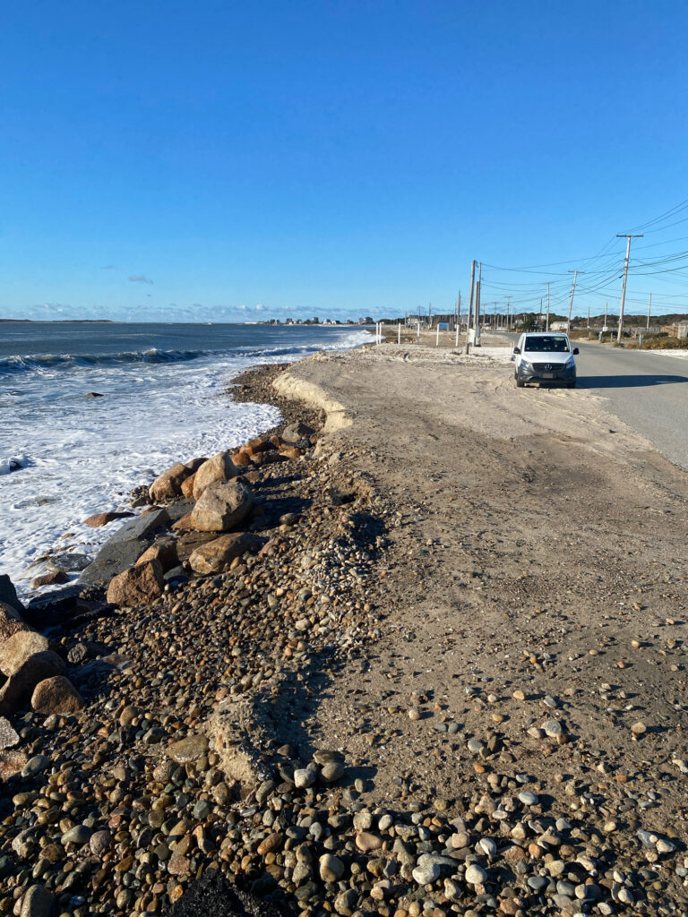 a car driving on a road next to a body of water (MyCoast AI)