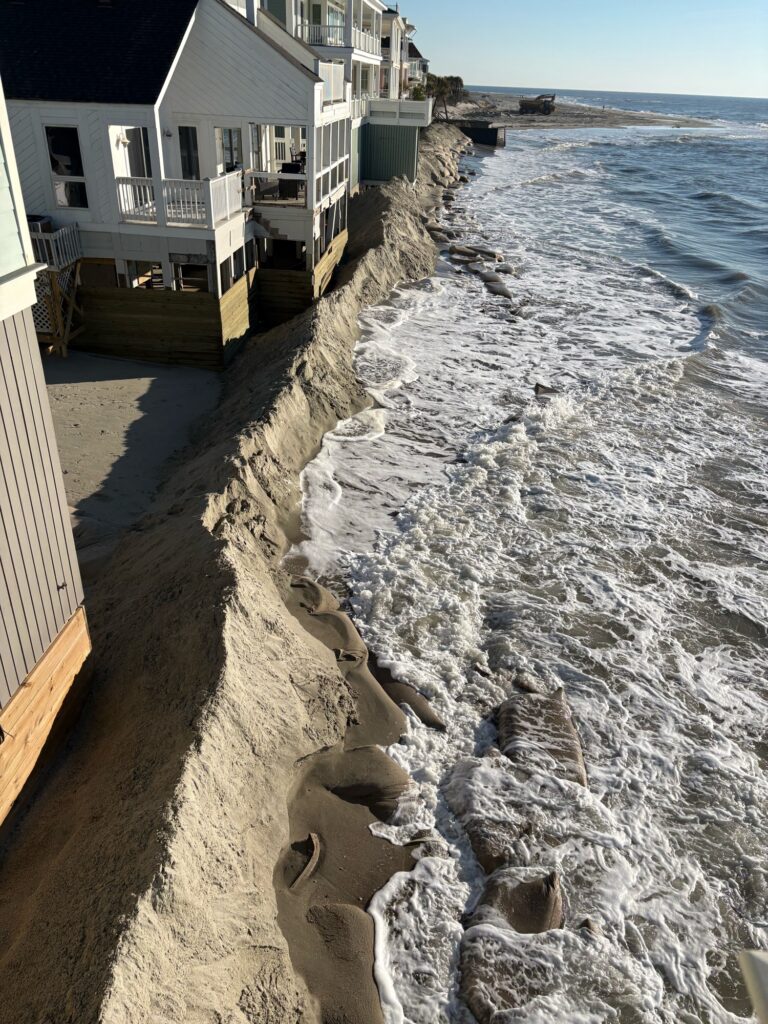 a beach with a house and water (MyCoast AI)