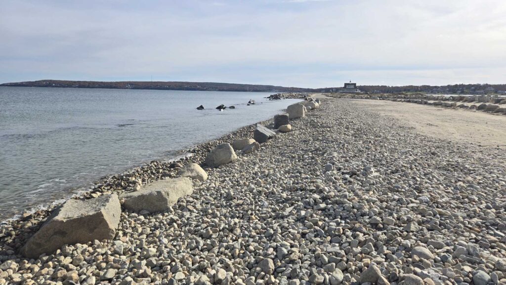 a rocky beach with a body of water in the background (MyCoast AI)