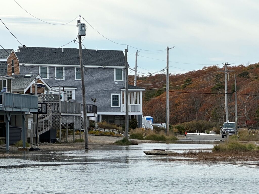 a flooded street with houses and power lines (MyCoast AI)