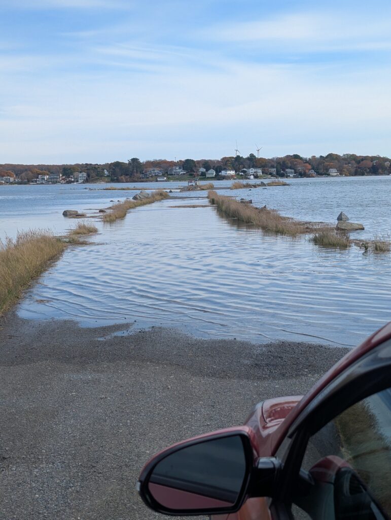 a car driving on a road next to a body of water (MyCoast AI)