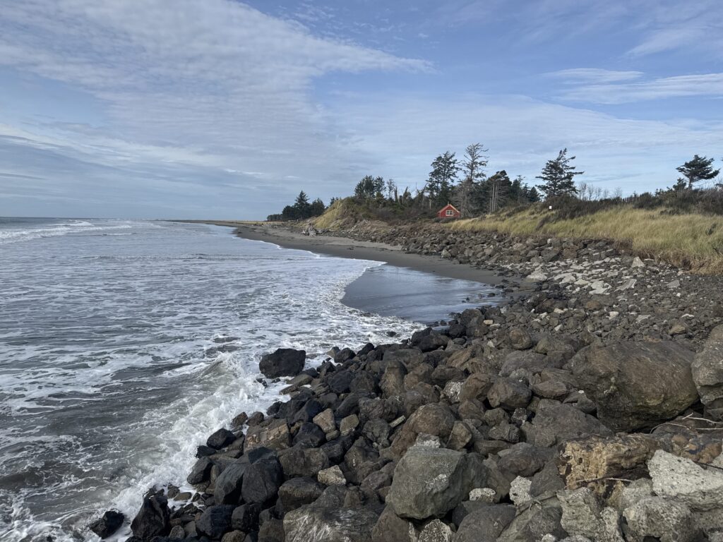 a rocky beach with a small house (MyCoast AI)
