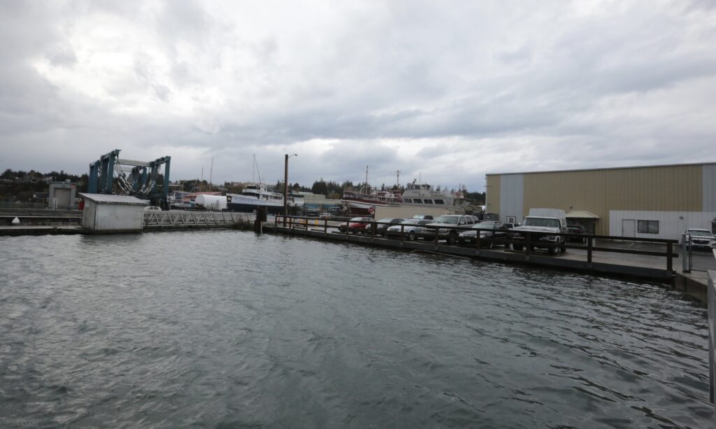 a body of water with a dock and buildings along it (MyCoast AI)