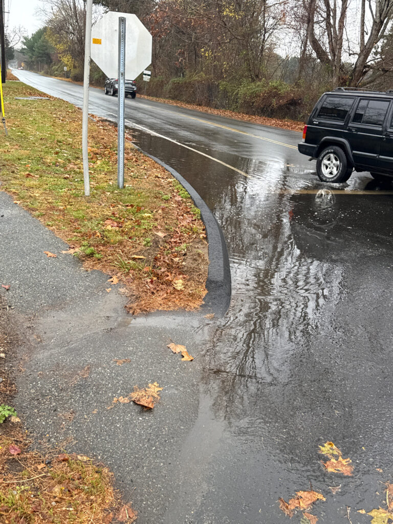 a flooded road with a car parked on the side (MyCoast AI)