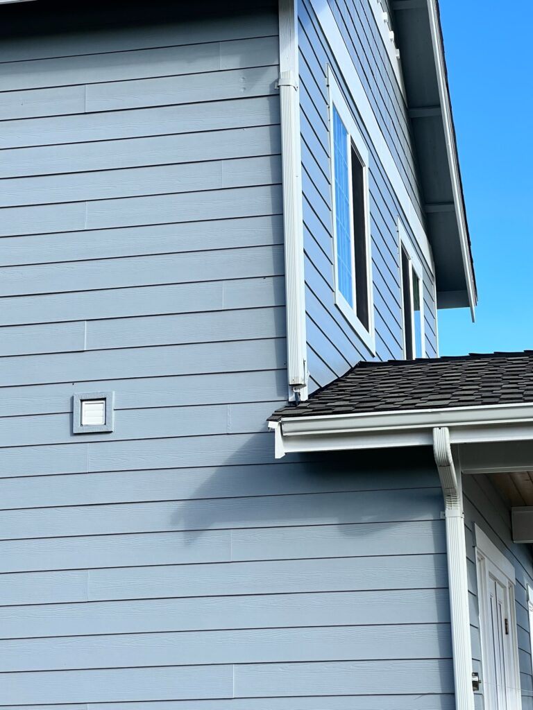 a white house with a blue sky (MyCoast AI)
