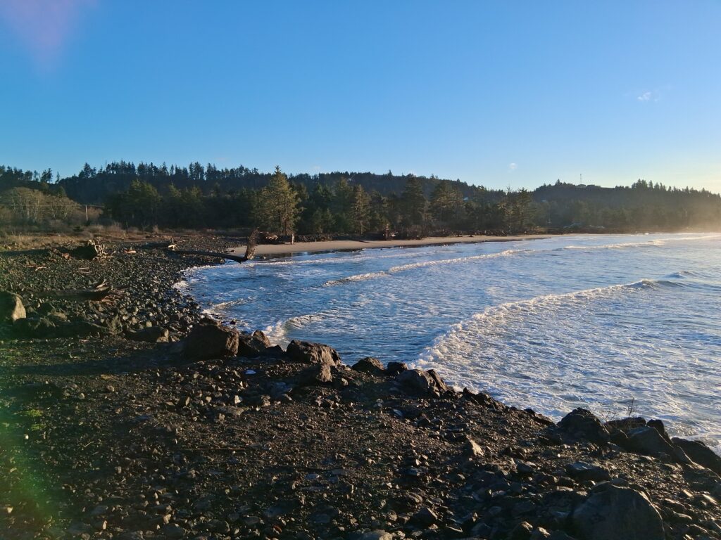 a body of water with rocks and trees in the background (MyCoast AI)