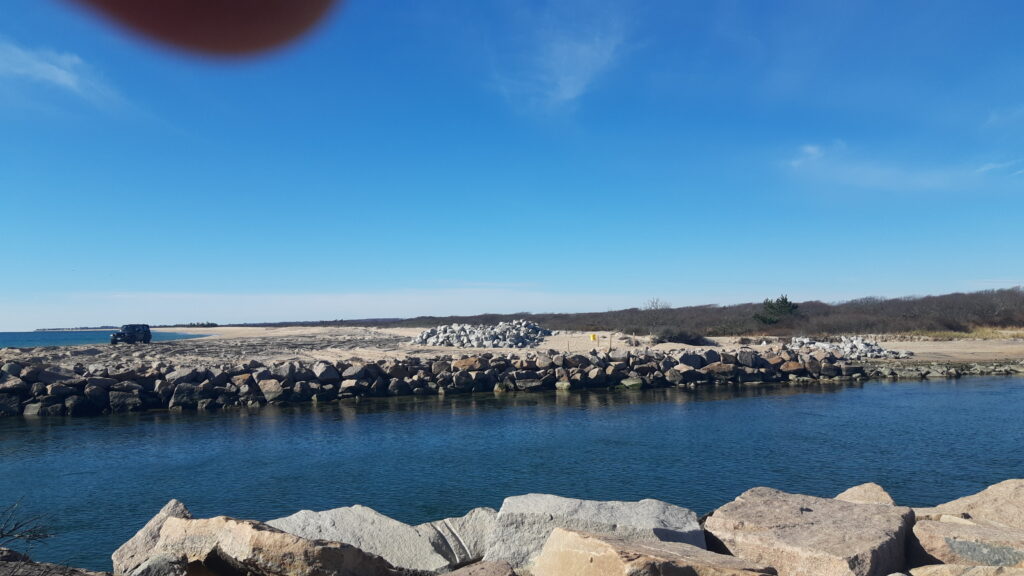 a body of water with rocks and trees in the background (MyCoast AI)