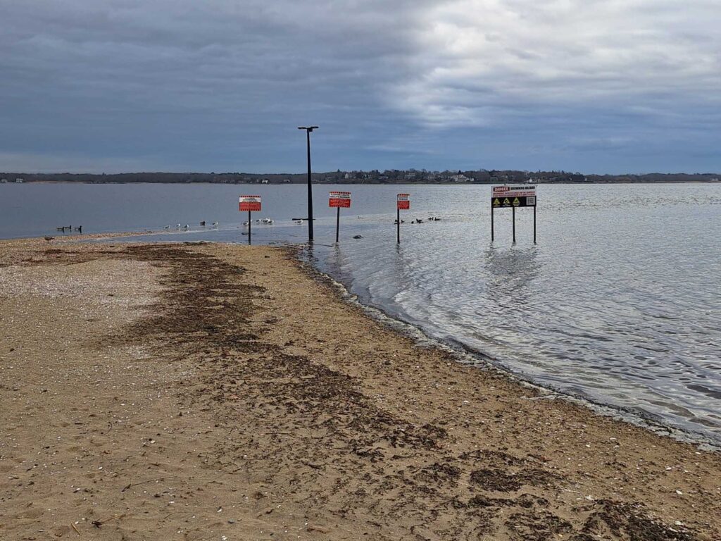 a beach with signs and a body of water (MyCoast AI)
