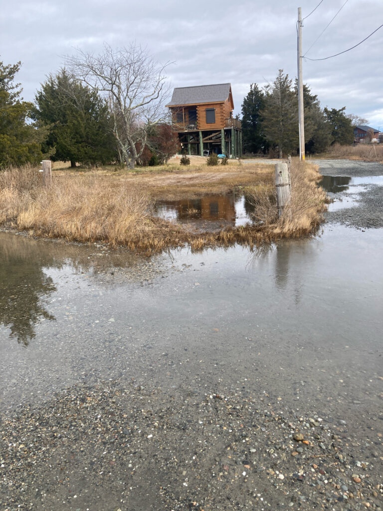 a flooded area with a house in the background (MyCoast AI)