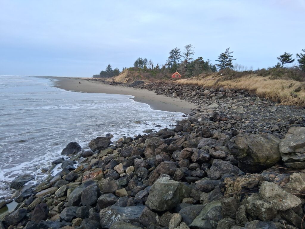 a rocky beach with a tent (MyCoast AI)